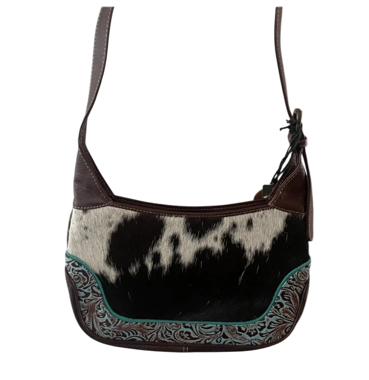 Hobo bag with cowhide pattern and decorative trim on a white background