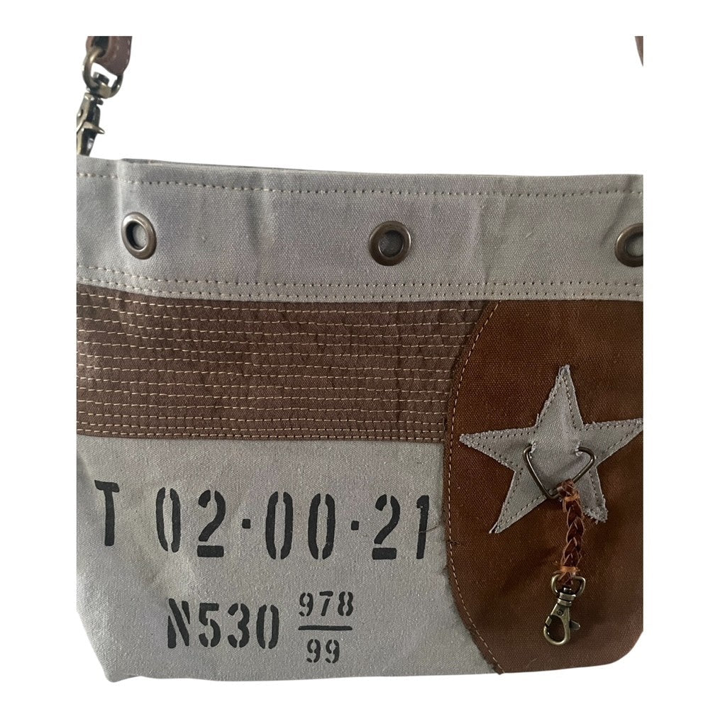Small pouch with star design and text on a white background
