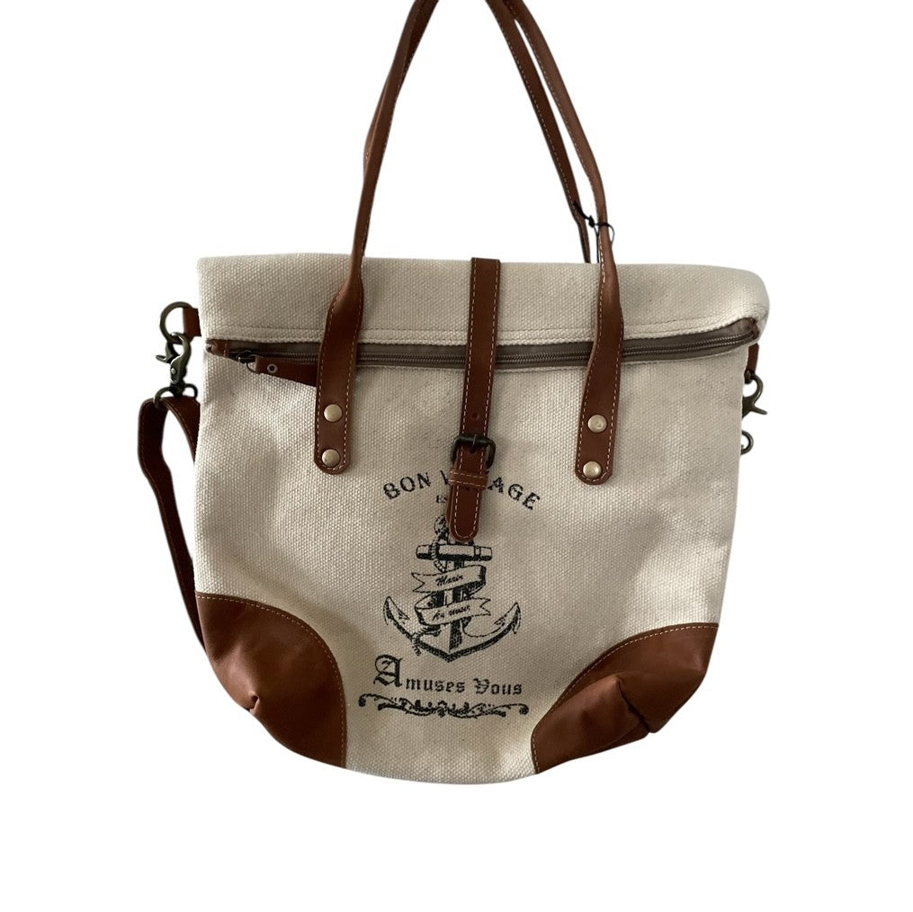 Canvas tote bag with brown leather accents and a ship design on a white background