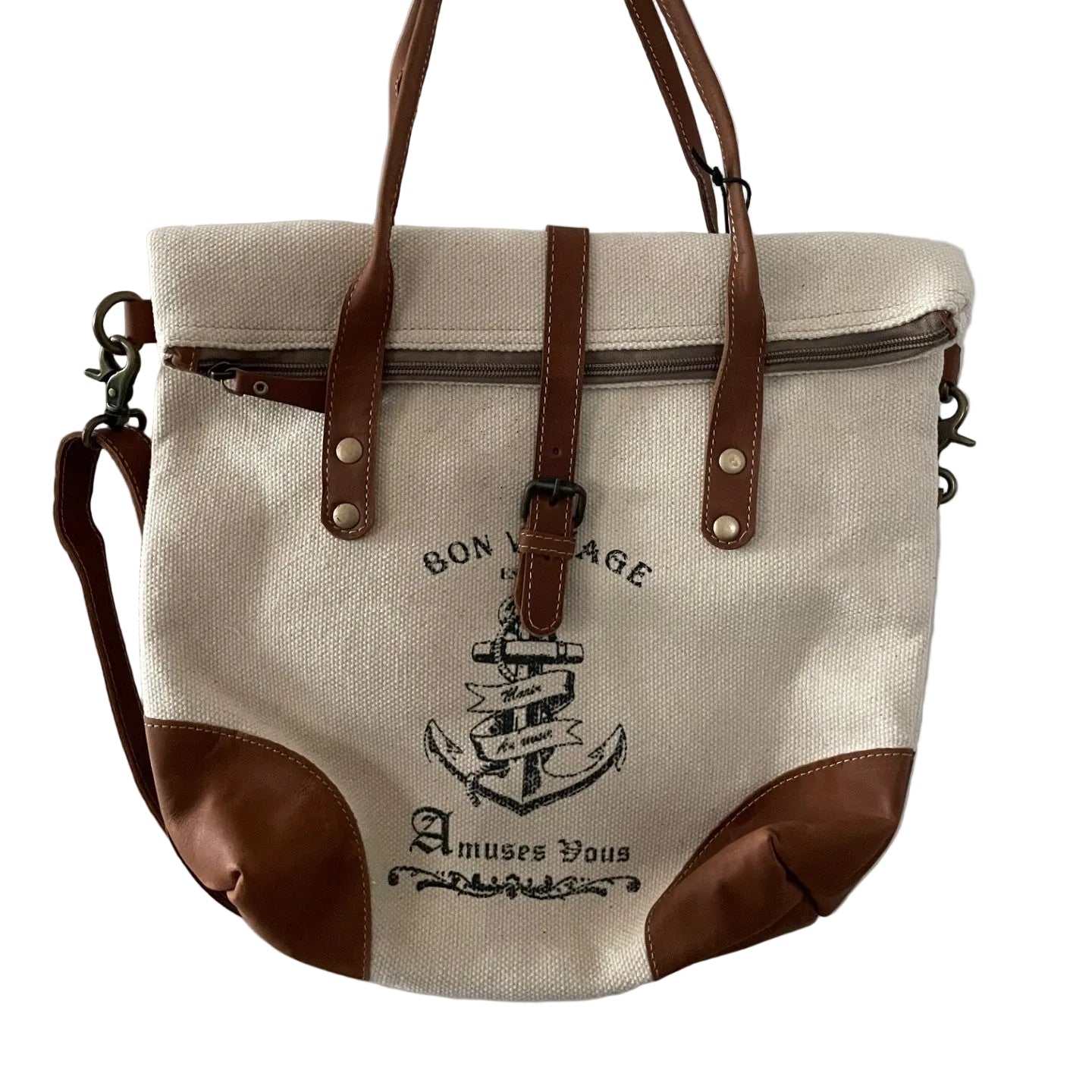 Canvas tote bag with brown leather straps and accents, featuring an anchor design, hanging on a white door.