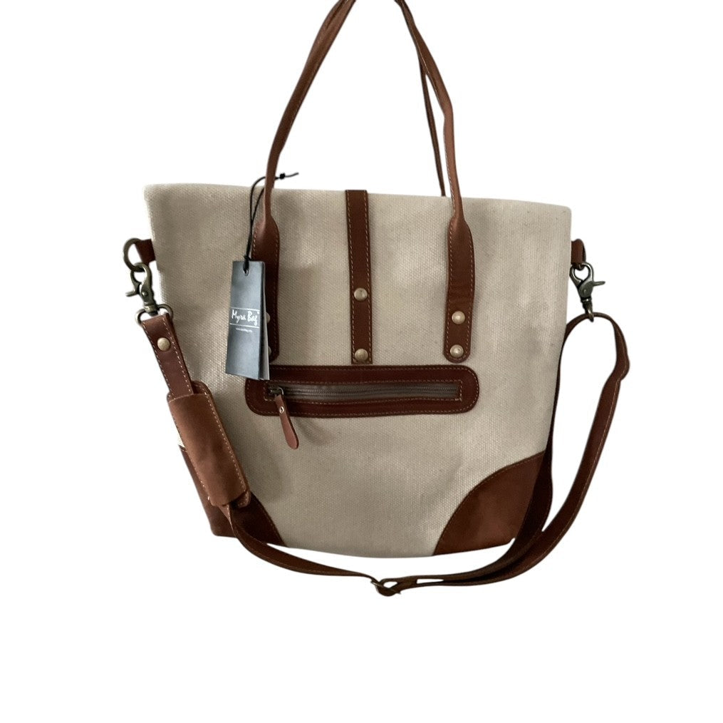 Beige tote bag with brown accents and a visible tag on a white background