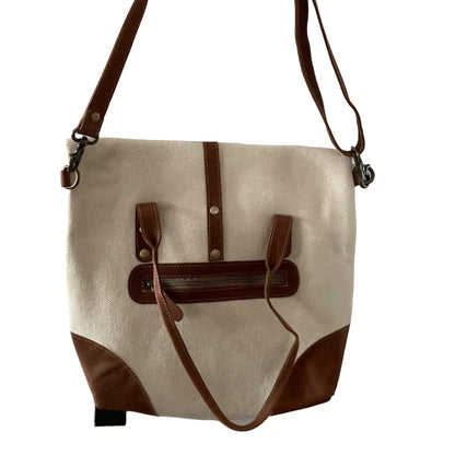 Beige and brown bag hanging on a white door handle.