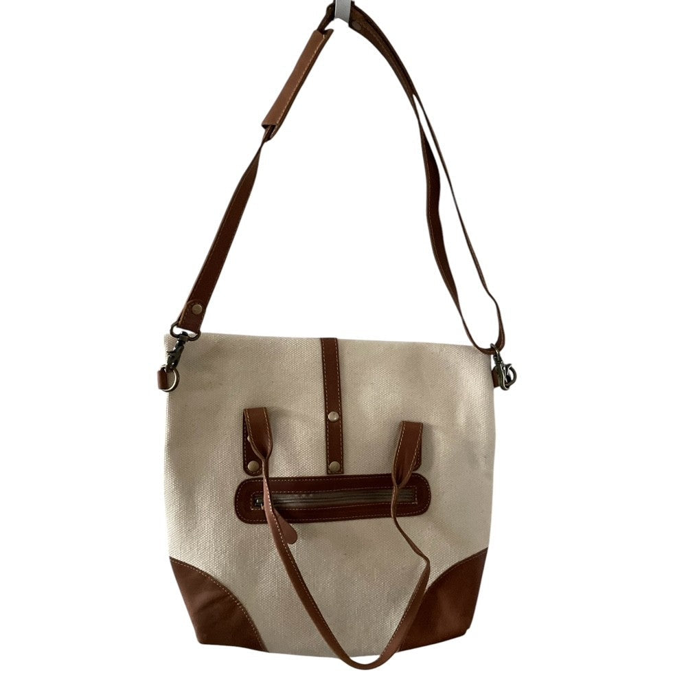 Canvas handbag with brown leather accents on a white background