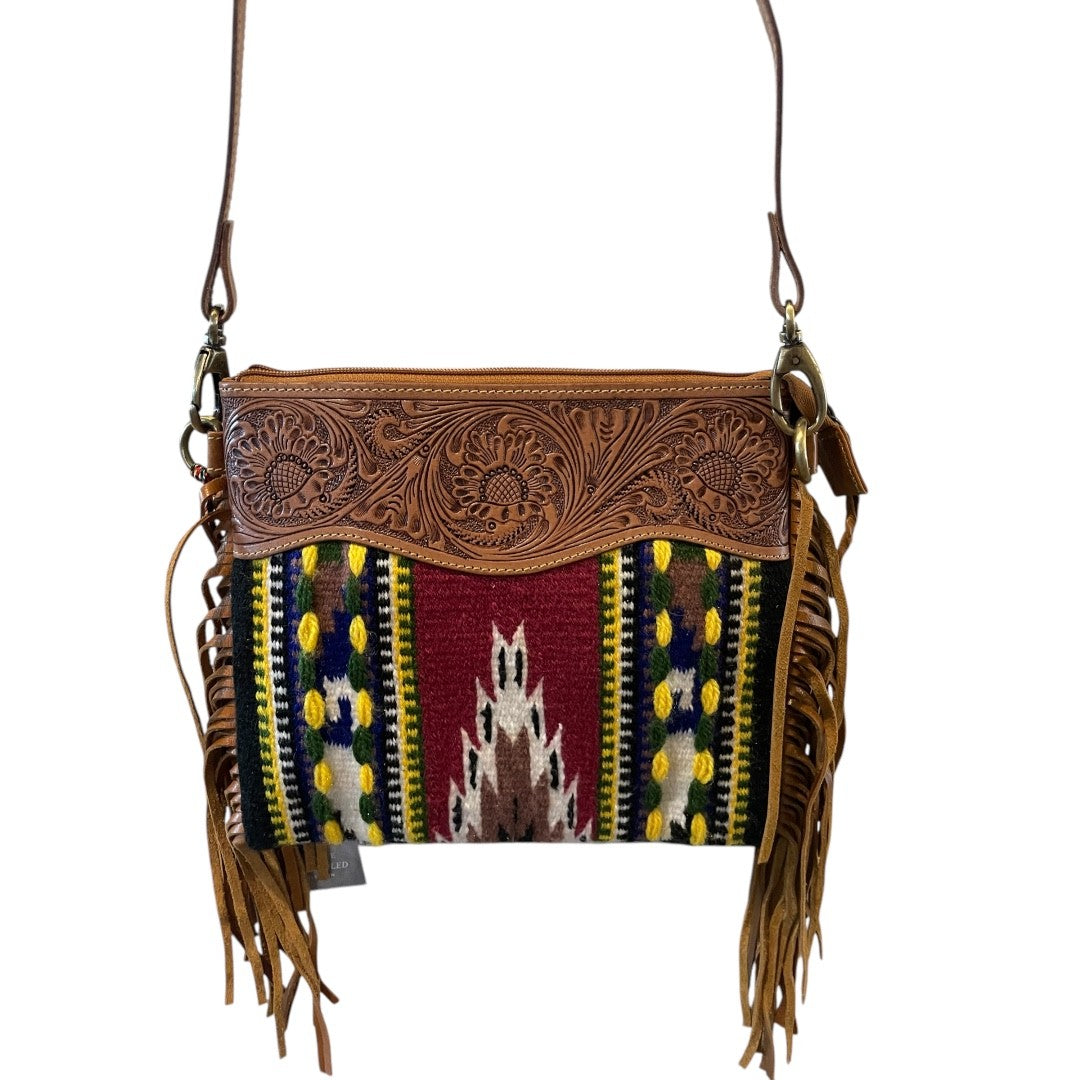 Brown leather and colorful patterned fabric crossbody bag with fringes on a white background