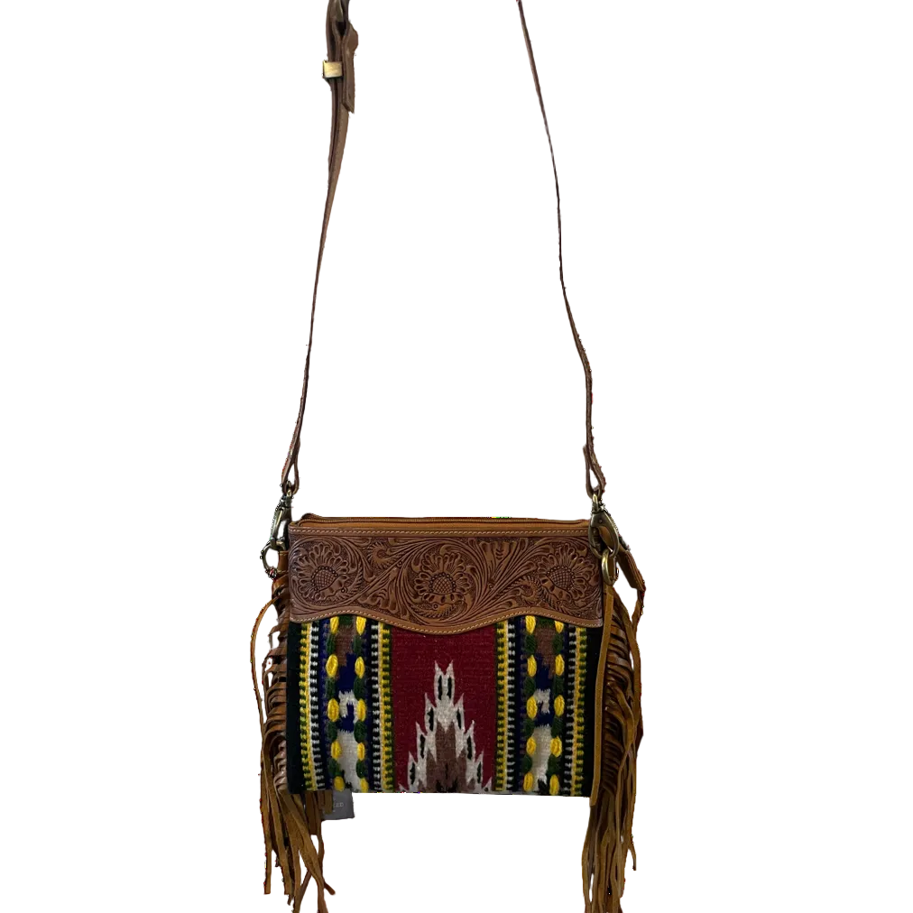 Brown leather crossbody bag with colorful patterned flap on a white background