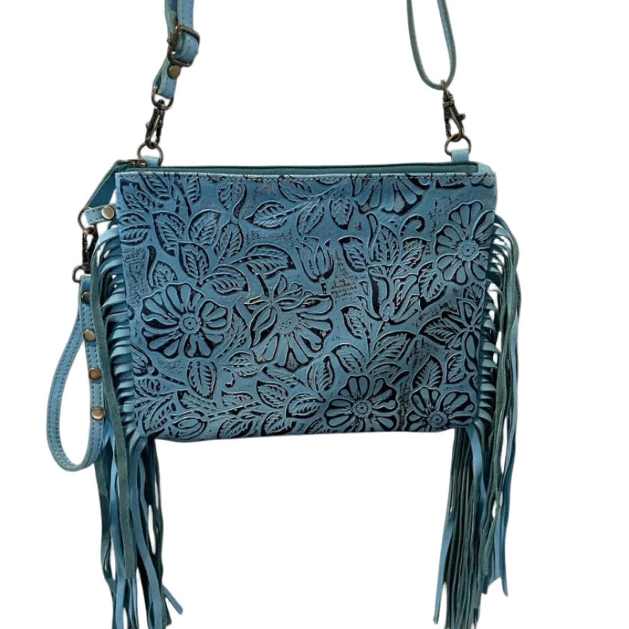 Blue leather handbag with floral patterns and fringes on a white background