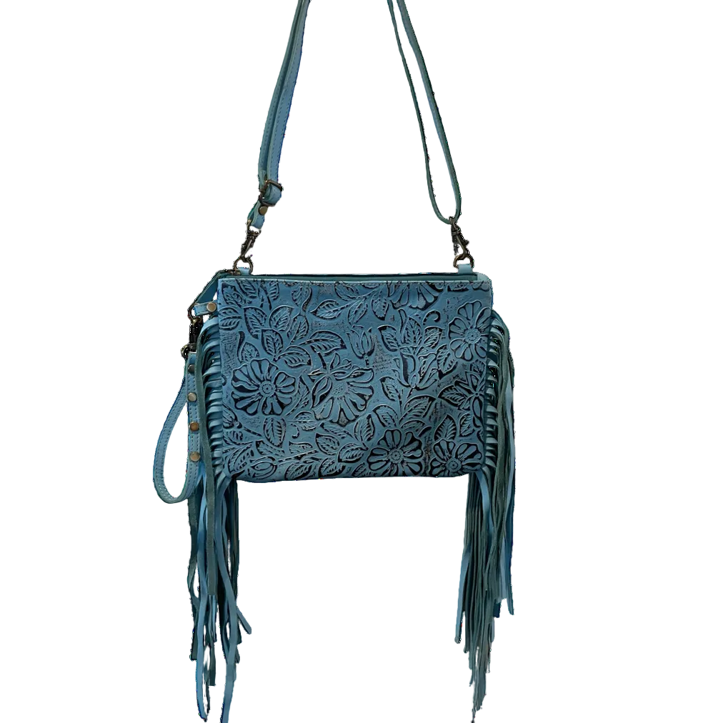 Blue leather handbag with fringe details on a white background