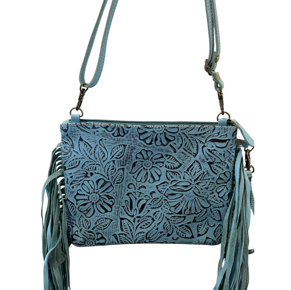 Blue leather crossbody bag with floral patterns and fringe on a white background