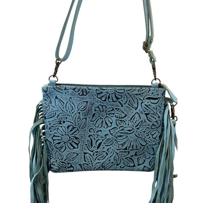 Blue leather crossbody bag with floral patterns and fringe on a white background