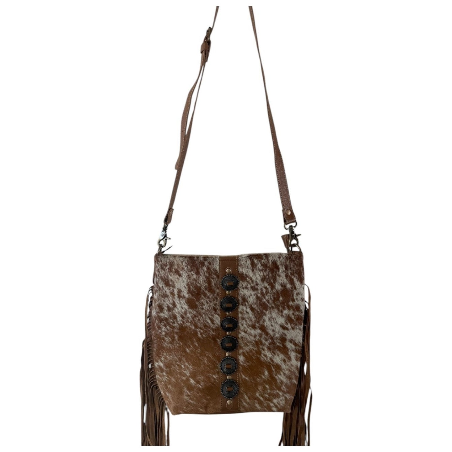 Brown and white cowhide leather crossbody bag with fringes on a white background