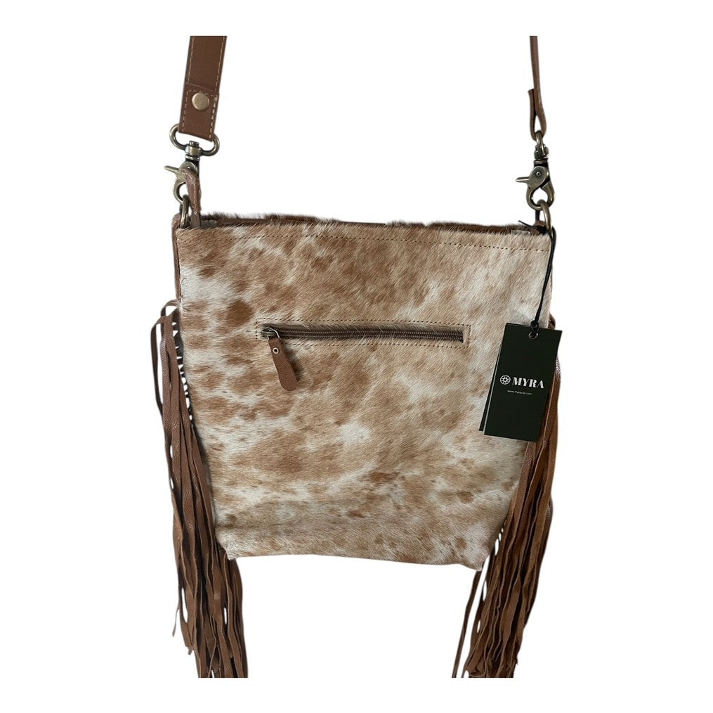 Cowhide leather crossbody bag with fringes and a visible brand tag on a white background
