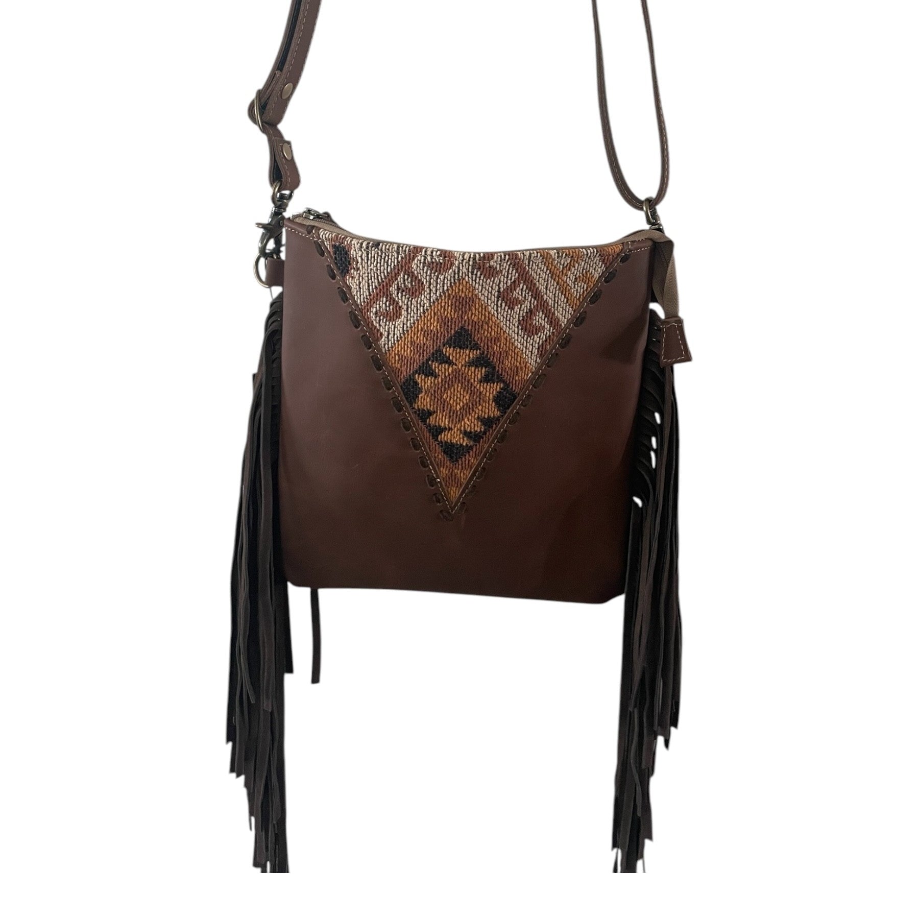 Brown leather handbag with patterned flap and fringes on a white background