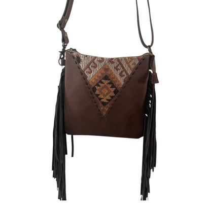 Brown leather handbag with patterned flap and fringes on a white background