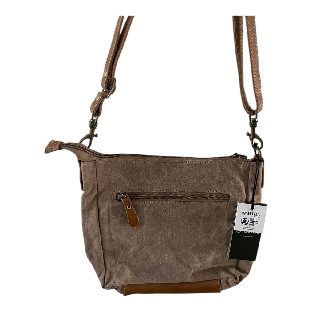 Brown leather handbag with a strap on a white background