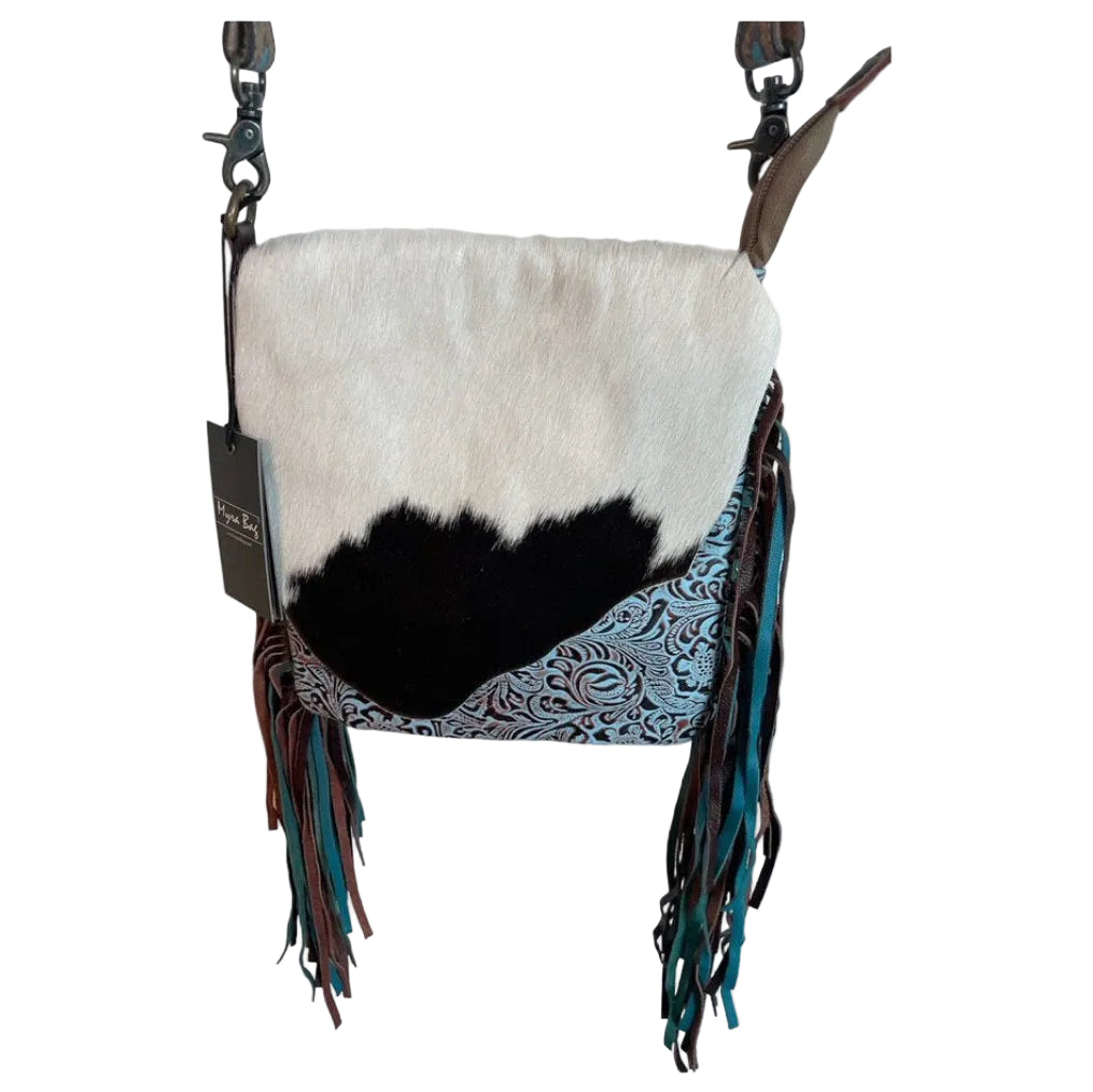 Cowhide leather bag with fringe details on a white background