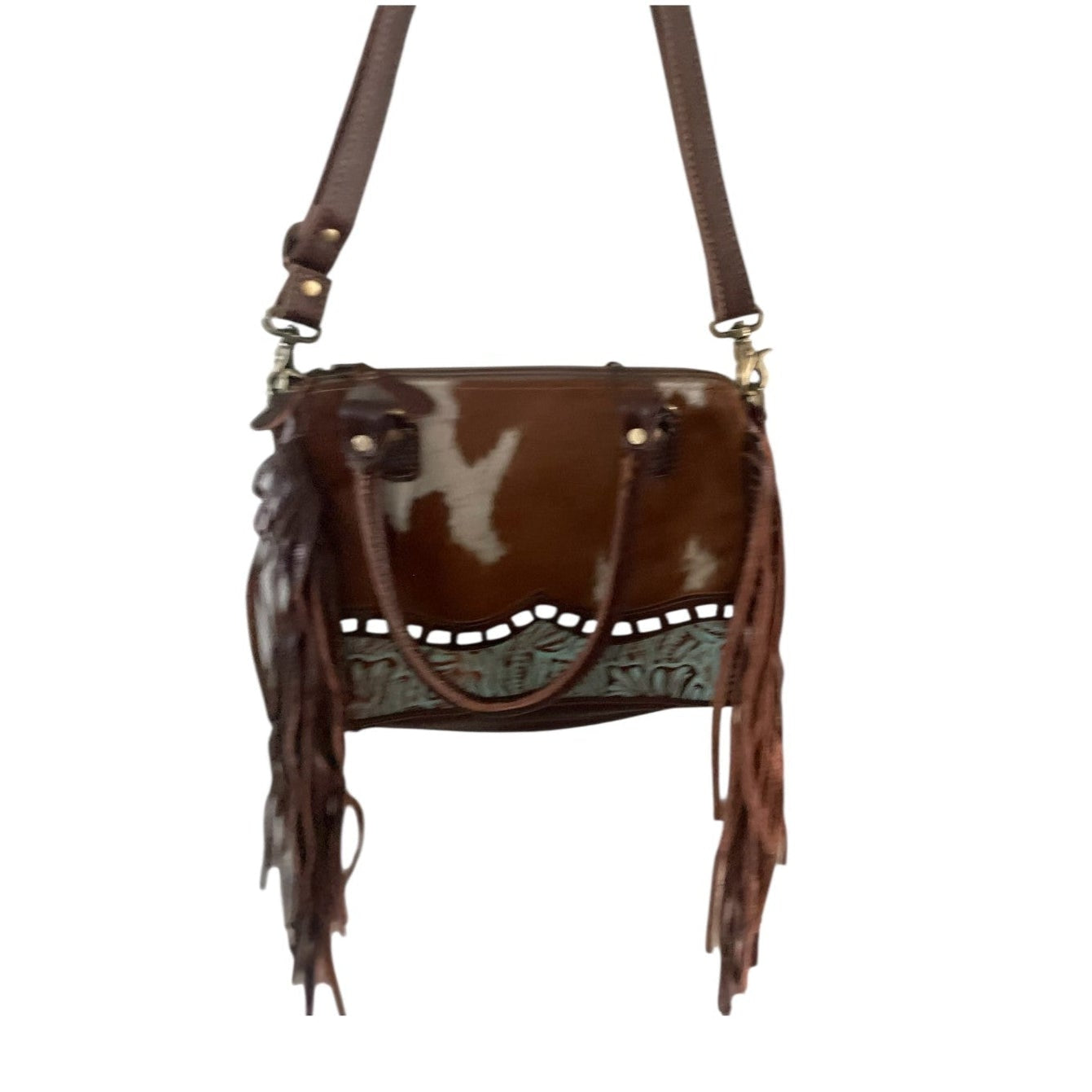 Brown leather handbag with fringe details on a white background