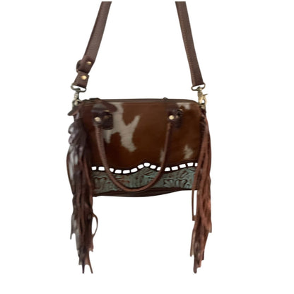 Brown leather handbag with fringe details on a white background