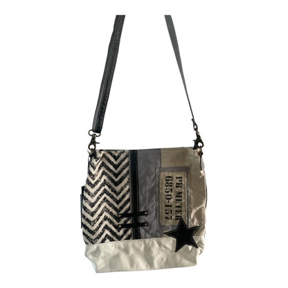 Crossbody bag with zigzag pattern and star design on a white background