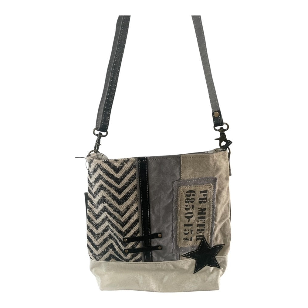 Textured shoulder bag with star design on a white background