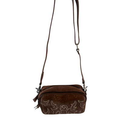 Brown crossbody bag with decorative patterns on a white background