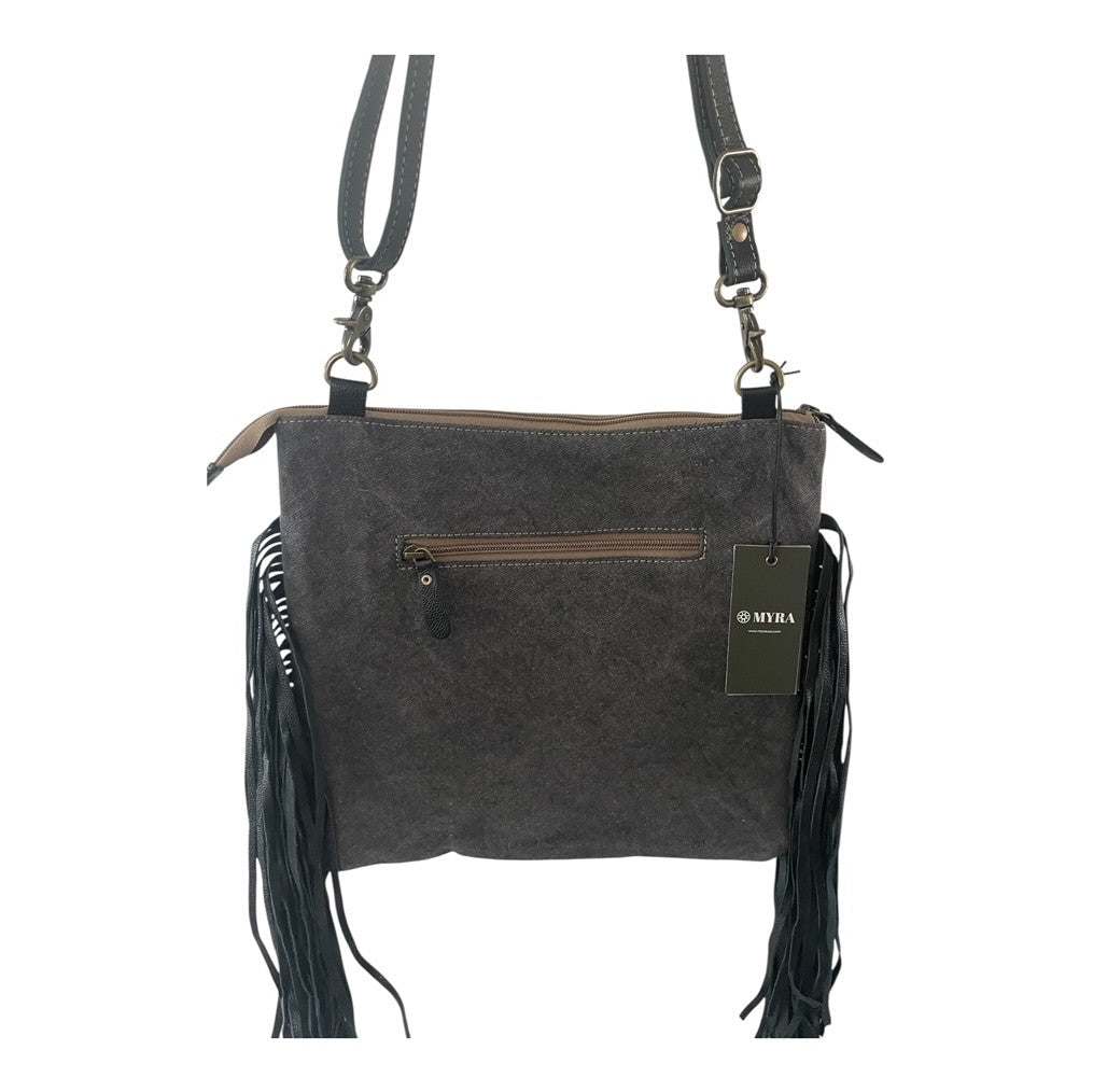 Gray crossbody bag with fringes and a visible brand tag on a white background