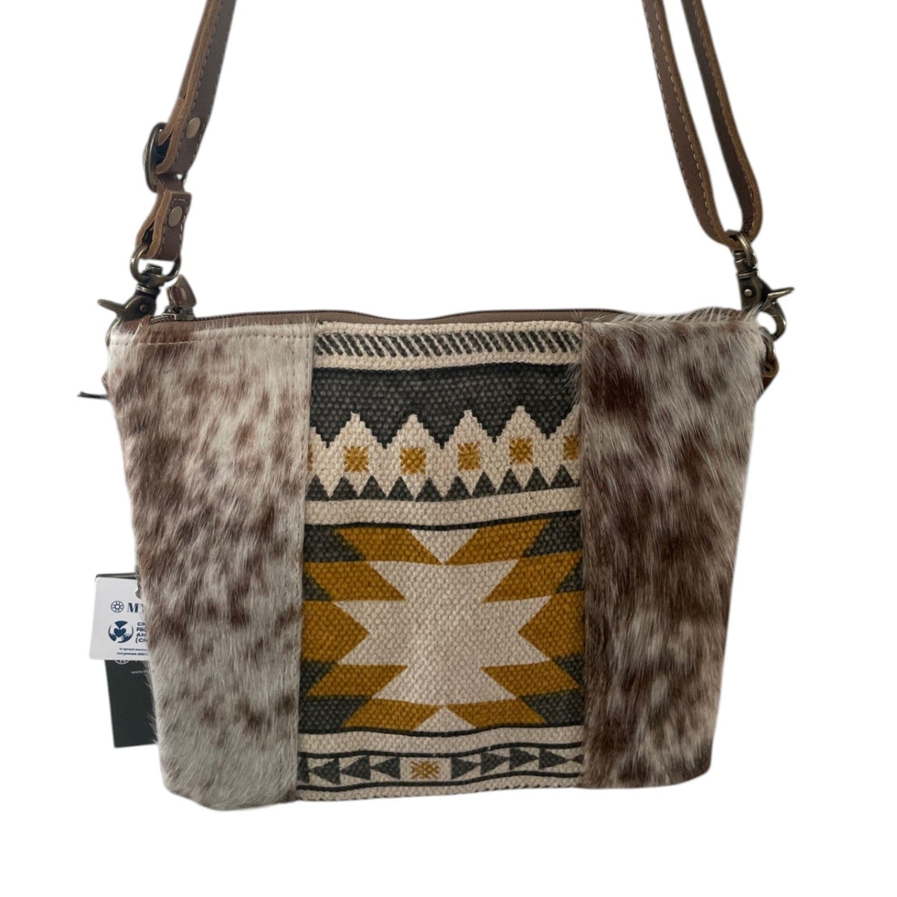 Crossbody bag with patterned fabric and fur accents on a white background