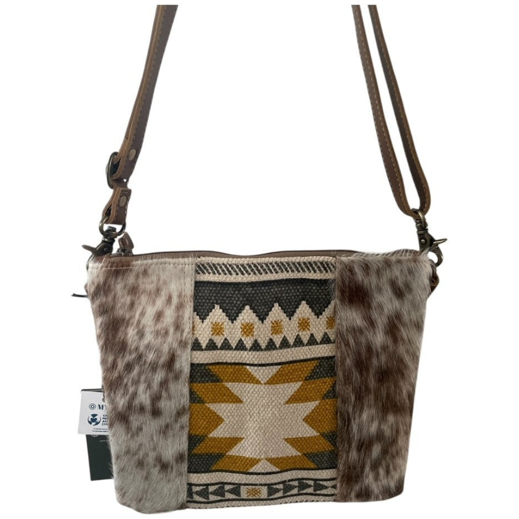 Crossbody bag with cowhide leather and geometric pattern on a white background