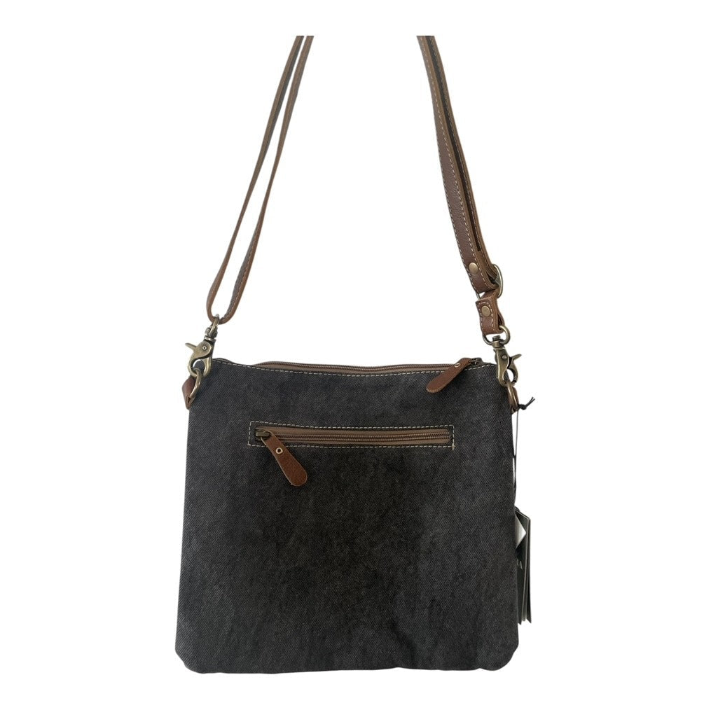Black leather handbag with brown accents on a white background
