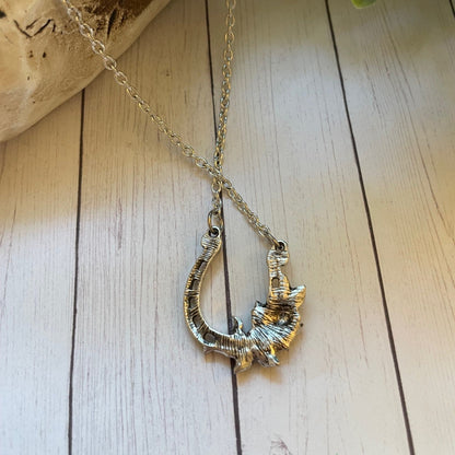 Silver necklace on a wooden surface