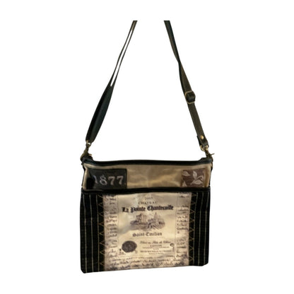 Handbag with vintage newspaper print on a white background