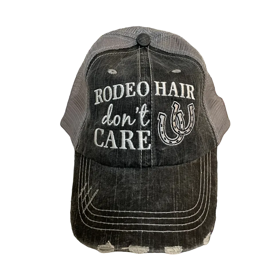 Black and gray cap with 'Rodeo Hair Don't Care' text and horseshoe design on a white background