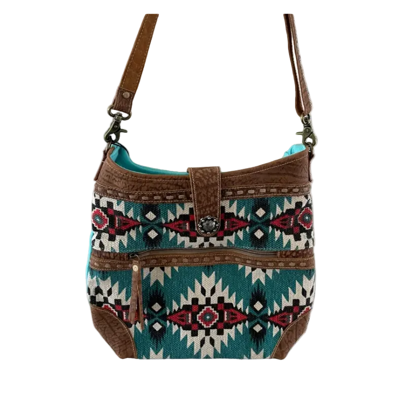 Handbag with tribal pattern and brown leather accents on a white background