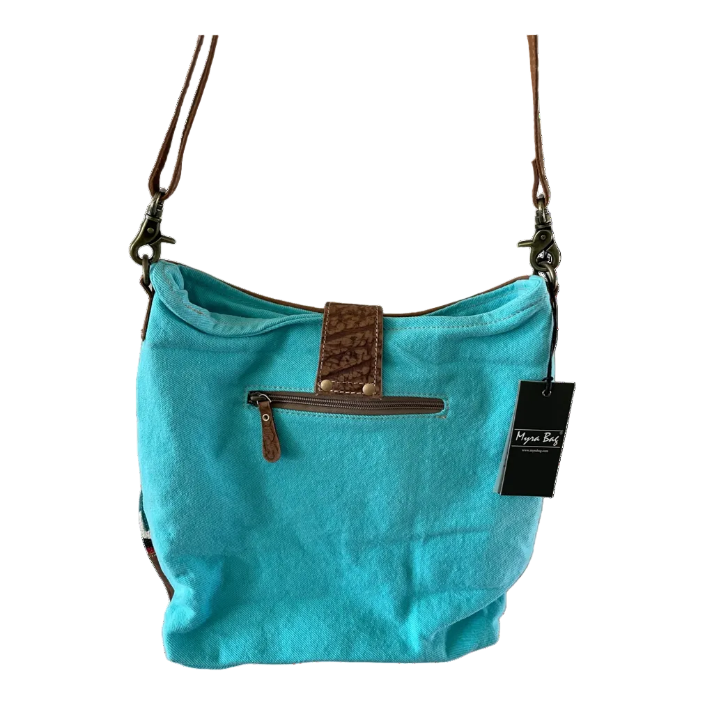 Turquoise handbag with brown leather accents on a white background