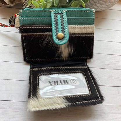 Small wallet with a green strap on a wooden surface
