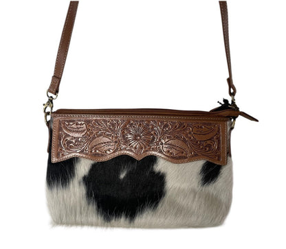 Cowhide handbag with decorative brown leather flap on a white background