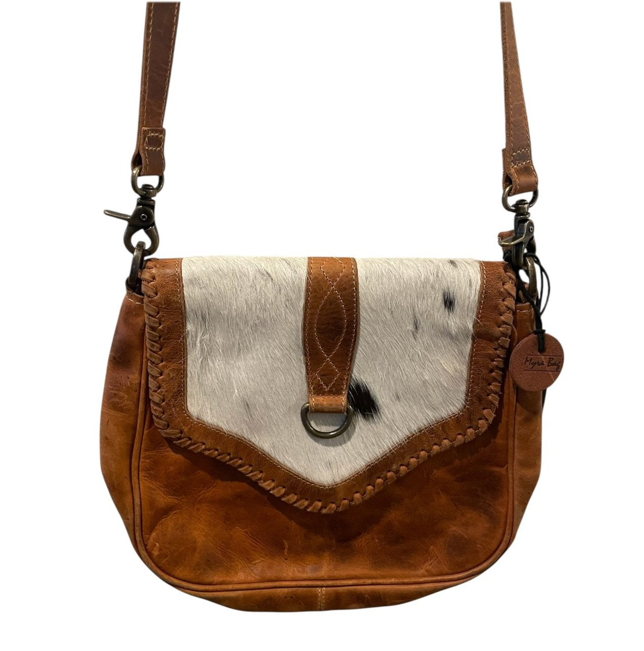 Brown leather and cowhide crossbody bag on a white background