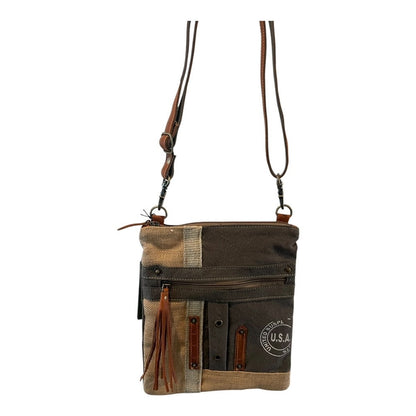 Patchwork-style handbag with leather accents on a white background