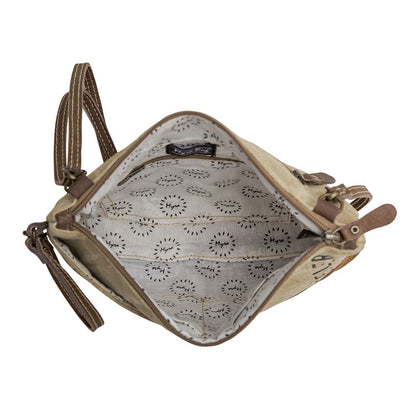Small beige bag with floral patterned interior on a white background