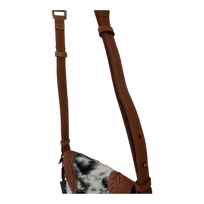 Brown leather strap with a black and white cowhide patch on a white background