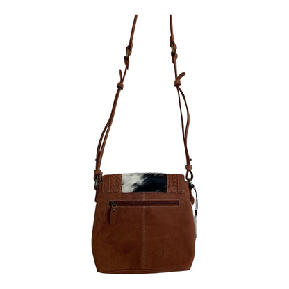 Brown leather handbag with a unique design on a white background
