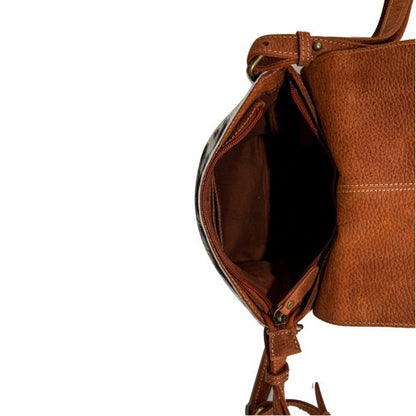 Brown leather bag with strap on a white background
